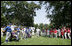 President George W. Bush welcomes players and guests to the White House Sunday, July 30, 2006, for the Tee Ball on the South Lawn game between the Thurmont Little League Civitan Club of Frederick Challengers of Thurmont, Md., and the Shady Spring Little League Challenger Braves of Shady Spring, W. Va.