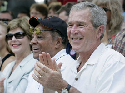 President George W. Bush and Laura Bush are joined by baseball legend and hall of famer Willie Mays, Tee Ball Commissioner for the day Sunday, July 30, 2006, at the Tee Ball on the South Lawn game between the Thurmont Little League Civitan Club of Frederick Challengers of Thurmont, Md., and the Shady Spring Little League Challenger Braves of Shady Spring, W. Va.