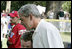 President George W. Bush embraces a South Lawn buddy volunteer Sunday, July 30, 2006, on the South Lawn of the White House at the conclusion of the Tee Ball on the South Lawn game between the Thurmont Little League Civitan Club of Frederick Challengers of Thurmont, Md., and the Shady Spring Little League Challenger Braves of Shady Spring, W. Va.