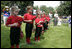 Members of the Luray, Virginia Red Wings hold their caps over their hearts during the playing of the national anthem Wednesday, June 27, 2007, prior to the start of the 2007 White House Tee Ball opener against the Bobcats of Cumberland, Maryland.