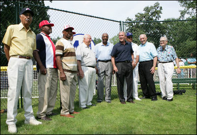 President George W. Bush, joined Baseball Hall of Fame player and honorary tee ball commissioner Frank Robinson, center, along with Hall of Fame manager Tommy Lasorda and fellow legendary players, retire the number of baseball great Jackie Robinson at the White House Tee Ball Game Sunday, July 15, 2007, on the South Lawn of the White House. All players wore the number 42 to celebrate the legacy of Jackie Robinson.