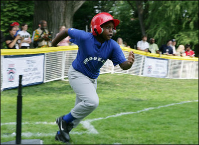 A player from the Inner City Little League of Brooklyn, N.Y. runs for first base after his hit against the Wrigley Little League Dodgers of Los Angeles Sunday, July 15, 2007 at the White House Tee Ball Game, in honor of legendary baseball player Jackie Robinson.