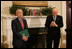 Vice President Dick Cheney applauds Lieutenant Bernard W. Bail, recipient of the Distinguished Service Cross, in the Roosevelt Room at the White House, Friday, February 24, 2006. The Vice President awarded the Distinguished Service Cross to Lt. Bail for his extraordinary acts of heroism during World War II and commended Lt. Bail for being a "brave citizen who elevated service to country above self interest."