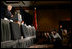 Press photographers steady their cameras as Vice President Dick Cheney delivers remarks to members of the American Legion, a community-service organization made up of nearly three million war-time veterans, during the organization's annual conference in Washington, Tuesday, February 28, 2006.