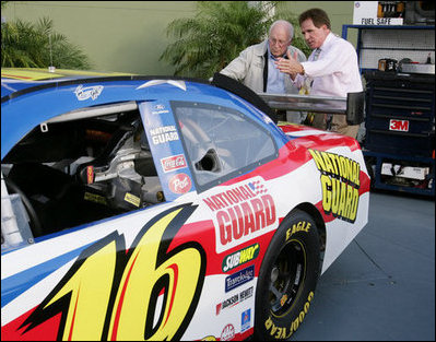 Vice President Dick Cheney is shown the National Guard NASCAR racing car by former NASCAR driver and Winston Cup champion Darrell Waltrip Saturday, July 1, 2006, prior to the start of the 2006 Pepsi 400 race at Daytona International Speedway in Daytona, Fla.