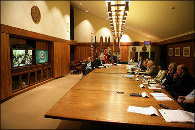 Vice President Dick Cheney and members of the Interagency Team on Iraq participate in a video teleconference with President George W. Bush in Baghdad, Tuesday, June 13, 2006.