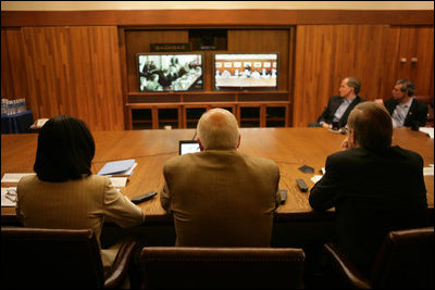 Vice President Dick Cheney, Secretary of Defense Donald Rumsfeld, right, and Secretary of State Condoleezza Rice, left, participate in a video teleconference from Camp David, Md., Tuesday, June 13, 2006 as President Bush meets Iraqi Prime Minister Nouri al-Maliki in Baghdad. The President expressed praise for Prime Minister Maliki's efforts in assembling a strong and diverse unity government in Iraq and said, "I want to thank you for giving me and my cabinet a chance to hear from you personally and a chance to meet the members of this team you've assembled. It's an impressive group of men and women, and if given the right help, I'm convinced you will succeed, and so will the world."