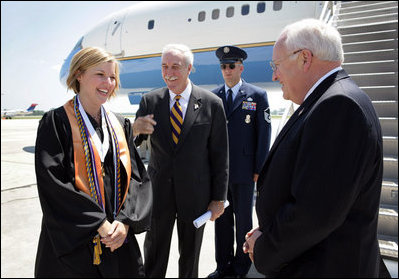 Upon landing in Louisana, Vice President Dick Cheney talks with Louisiana State University Student Body President Michelle Gieg and Chancellor Sean O'Keefe alongside Air Force Two. The Vice President delivered the commencement address to over 3,000 bachelors, masters, and doctoral students.