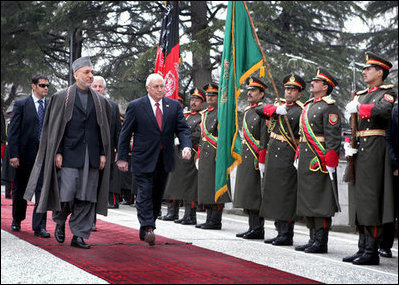 Vice President Dick Cheney and Afghan President Hamid Karzai review an honor guard, Tuesday, Feb. 27, 2007 during the Vice President's arrival to the presidential palace in Kabul.