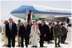 Vice President Dick Cheney, former Secretary of State Colin Powell, and former President George H.W. Bush are escorted from the plane by members of the Saudi delegation before meeting with the newly crowned King Abdullah of Saudi Arabia Friday, August 05, 2005. Vice President Dick Cheney led a delegation to pay respects following the recent death of King Fahd.