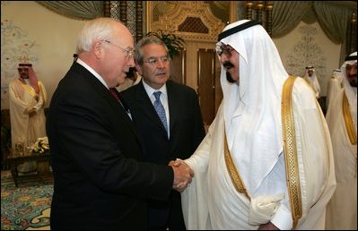 Vice President Dick Cheney, left, shake hands with newly crowned King Abdullah, right, during a retreat at King Abdullah's Farm in Riyadh, Saudi Arabia Friday, August 5, 2005, following the death of his half-brother King Fahd who passed away August 1, 2005. Interperter Gamal Helal, center, is also pictured.