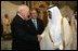 Vice President Dick Cheney, left, shake hands with newly crowned King Abdullah, right, during a retreat at King Abdullah's Farm in Riyadh, Saudi Arabia Friday, August 5, 2005, following the death of his half-brother King Fahd who passed away August 1, 2005. Interperter Gamal Helal, center, is also pictured.