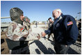 Vice President Dick Cheney visits the 9th Mechanized Infantry Division Headquarters at Taji Air Base to greet Iraqi troops and view tanks and armored vehicles they have refurbished into working fighting vehicles, Sunday Dec. 18, 2005.