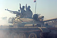 Vice President Dick Cheney visits the 9th Mechanized Infantry Division Headquarters at Taji Air Base to greet Iraqi troops and view tanks and armored vehicles they have refurbished into working fighting vehicles, Sunday Dec. 18, 2005.