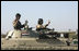 Vice President Dick Cheney visits the 9th Mechanized Infantry Division Headquarters at Taji Air Base to greet Iraqi troops and view tanks and armored vehicles they have refurbished into working fighting vehicles, Sunday Dec. 18, 2005.