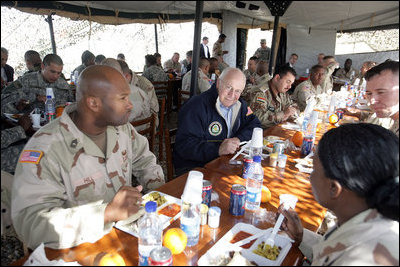 Vice President Dick Cheney has lunch with US and Iraqi troops at the 9th Mechanized Infantry Division Headquarters, a training facility for Iraqi troops, Sunday Dec 18, 2005.