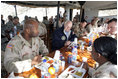 Vice President Dick Cheney has lunch with US and Iraqi troops at the 9th Mechanized Infantry Division Headquarters, a training facility for Iraqi troops, Sunday Dec 18, 2005.