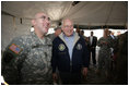 Vice President Dick Cheney has lunch with US and Iraqi troops at the 9th Mechanized Infantry Division Headquarters, a training facility for Iraqi troops, Sunday Dec 18, 2005.