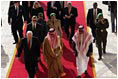 Followed by a group of Saudi and US delegates, Vice President Dick Cheney walks down a red carpet with Prince Saud al-Faisal bin Abdulaziz, Saudi Minister of Foreign Affairs, upon arrival to King Khalid International Airport in Saudi Arabia, Tuesday January 17, 2006.