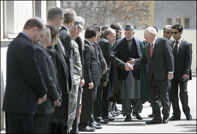 Vice President Dick Cheney is escorted by President of Afghanistan Hamid Karzai as he greets Afghan officials upon arrival to Gul Khana Palace in Kabul Thursday, March 20, 2008. The Vice President met with President Karzai and Afghan officials to reaffirm America's commitment to Afghanistan and discuss ways the U.S. would continue to help Afghanistan become a more prosperous and stable nation. 