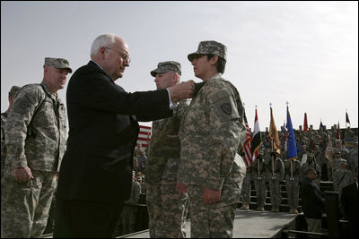 Vice President Dick Cheney awards PFC Veronica Alfaro with the Bronze Star Tuesday, March 18, 2008, during a rally for U.S. troops at Balad Air Base, Iraq. "I can't describe the feeling I had when he awarded me the Bronze Star," said Alfaro, 2nd Platoon senior medic, Bravo Company. "It is definitely a moment I will always remember and cherish; I will never forget it."