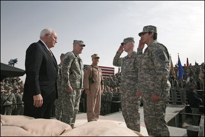 Staff Sgt. Shane Lindsey, second right, and PFC Veronica Alfaro, far right, salute Vice President Dick Cheney after being awarded the Bronze Star Tuesday, March 18, 2008, during a rally for U.S. troops at Balad Air Base, Iraq.