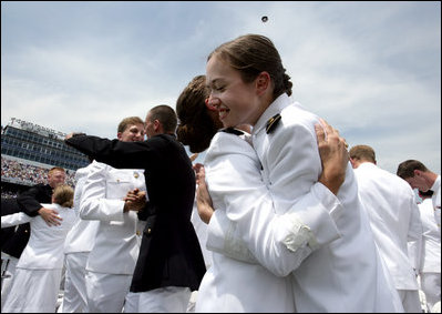 Graduates embrace at the conclusion of the Graduation and Commissioning Ceremony for the U.S. Naval Academy Class of 2006 in Annapolis, Maryland, Friday, May 26, 2006.