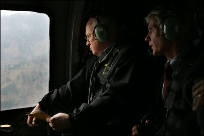 Vice President Dick Cheney and US Ambassador to Pakistan Ryan Crocker survey the devastation of Pakistan's earthquake zone Tuesday, December 20, 2005. At the peak of initial relief efforts, the U.S. had more than 1,200 personnel and 24 helicopters in the affected areas. American troops have flown more than 2,600 helicopter flights to deliver nearly 12 million pounds of relief supplies while US personnel have cared for more than 11,000 Pakistanis and supplied critical engineering support.