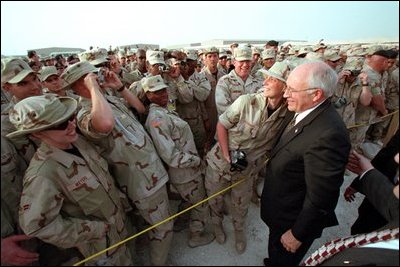 Troops at Al-Udeid Airbase in Qatar gather around Vice President Dick Cheney for pictures and handshakes March 17, 2002.