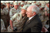 Troops at Al-Udeid Airbase in Qatar gather around Vice President Dick Cheney for pictures and handshakes March 17, 2002.