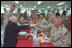 Stationed in Egypt, American troops are participating in an 11-country international peacekeeping force called the Multinational Force of Observers. Here, they share conversation and lunch with Vice President Dick Cheney during his visit to the base March 13, 2002. The MFO is an international peacekeeping force established by Egypt and Israel to monitor the security arrangements of their Treaty of Peace.