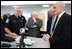 Vice President Dick Cheney, Senator Saxby Chambliss, and Department of Homeland Security Secretary Michael Chertoff listen as a U.S. Customs and Border Protection agent shows off some of the technology being used to train law enforcement personnel at the Federal Law Enforcement Training Center in Glynco, Georgia, May 2, 2005. The Vice President toured the facility, which provides training to more than 80 federal agencies, in addition to state and local police. The facility is the largest law enforcement training establishment in the country and graduates over 50,000 students annually.