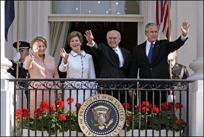 President George W. Bush, Prime Minister John Howard, Mrs. Laura Bush and Mrs. Janette Howard wave from the South Portico of the White House during the State Arrival Ceremony on the South Lawn Tuesday, May 16, 2006.