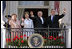 President George W. Bush, Prime Minister John Howard, Mrs. Laura Bush and Mrs. Janette Howard wave from the South Portico of the White House during the State Arrival Ceremony on the South Lawn Tuesday, May 16, 2006.