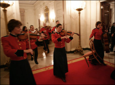 Roving musicians enter the State Dining Room, Monday, July 18, 2005 at the White House, at the official dinner in honor of the visit by India's Prime Minister Dr. Manmohan Singh. White House photo by Eric Draper