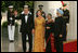 President George W. Bush and Laura Bush welcome India Prime Minister Dr. Manmohan Singh and Mrs. Gursharan Kaur, as they arrive for the official dinner at the White House, Monday, July 18, 2005. White House Photo by Krisanne Johnson