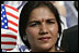 A guest attending the official arrival of India's Prime Minister Dr. Manmohan Singh, holds an American and India flag, Monday, July 18, 2005, on the South Lawn of the White House. 