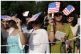 Invited guests shade their eyes, Monday, July 18, 2005, during the official arrival ceremony for India's Prime Minister Manmohan Singh on the South Lawn of the White House. 