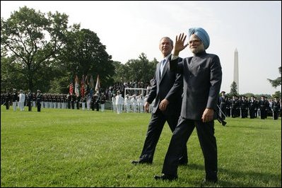 President George W. Bush walks with India's Prime Minister Dr. Manmohan Singh, Monday, July 18, 2005, on the South Lawn of the White House, during Singh's official arrival ceremony. 