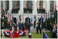 President Bush stands with India's Prime Minister Dr. Manmohan Singh, Monday, July 18, 2005 during the playing of the national anthems on the South Lawn of the White House. 