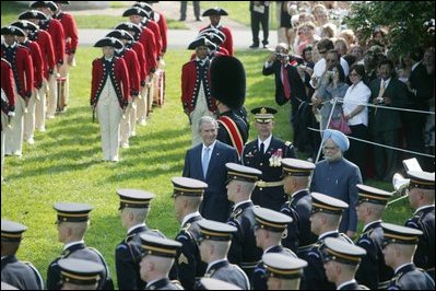 President George W. Bush reviews an honor guard with India's Prime Minister Dr. Manmohan Singh, Monday, July 18, 2005, on the South Lawn of the White House, during Singh's official arrival ceremony. 