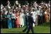 President George W. Bush and India's Prime Minister Dr. Manmohan Singh are cheered by invited guests, Monday, July 18, 2005 on the South Lawn of the White House, during the official arrival ceremony for Prime Minister Singh. 