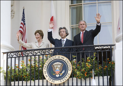 President George W. Bush, Laura Bush and Prime Minister Junichiro Koizumi of Japan wave from the Truman Balcony at the conclusion of the official arrival ceremony Thursday, June 29, 2006.