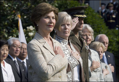 Mrs. Laura Bush stands with Lynne Pace and her husband, Chairman of the Joint Chiefs of Staff General Peter Pace, during the official arrival ceremony for Prime Minister Junichiro Koizumi of Japan on the South Lawn Thursday, June 29, 2006.