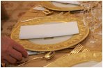 Last minute checks and adjustments are made on the table arrangements in the State Dining Room, Wednesday, Nov. 2, 2005, in preparations for the official dinner for the Prince of Wales and Duchess of Cornwall at the White House.