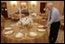 Last minute checks and adjustments are made on the table arrangements in the State Dining Room, Wednesday, Nov. 2, 2005, in preparations for the official dinner for the Prince of Wales and Duchess of Cornwall at the White House.