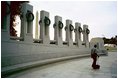 Ray Gresham, supervisor of the National Park Service.s Memorial Maintenance Crew, takes an early morning survey along the plaza encircled by 56 granite pillars. The new memorial is one of many sites that are maintained by Gresham.s crew, which cleans the National Park Service.s monuments and memorials every morning before tourists arrive.