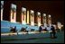 As night falls over the memorial, visitors cool off on the granite benches of the National World War II Memorial the week before its official dedication during Memorial Day Weekend.