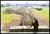 President and Mrs. Bush place a rose at the end of the railroad tracks at the Birkenau concentration camp, also known as Auschwitz II, in Poland, May 31, 2003.