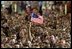 A veteran waves an American flag during President Bush's address to members of the Florida National Guard, veterans and retired members of the military at MacDill Air Force Base in Tampa, Fla., March 26, 2003. "I want to thank you all for your service, for setting such a clear example for future generations of those who wear our uniform. I think you'll agree that our military is not letting you down when it comes to upholding the great tradition of peace through strength.. said the President"